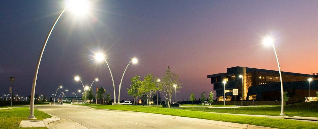 road next to Central Park building at night with street lights